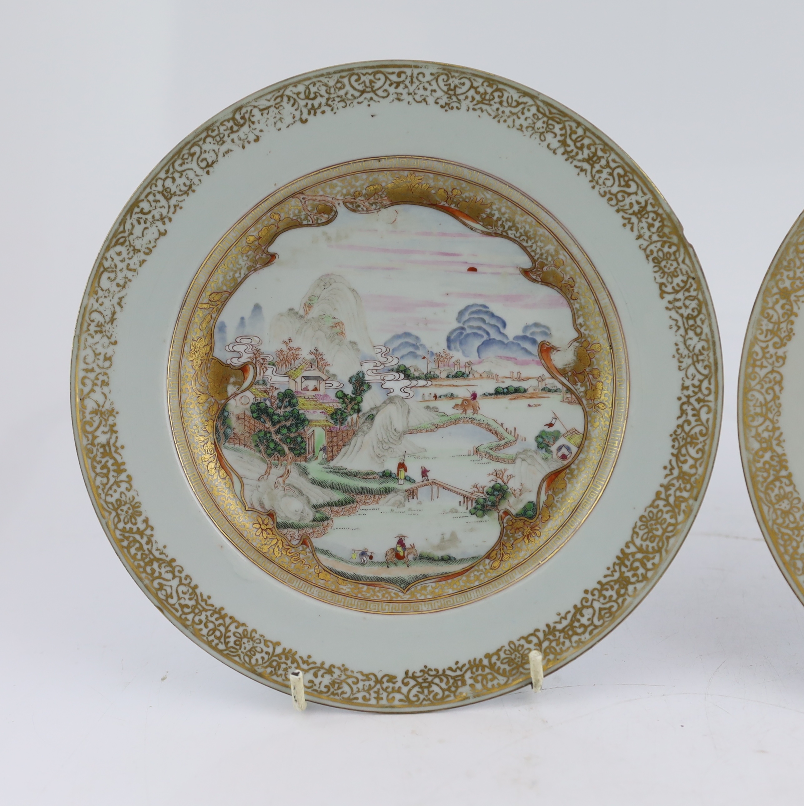 A pair of Chinese famille rose ‘landscape’ plates, Yongzheng-Qianlong period, small edge chip